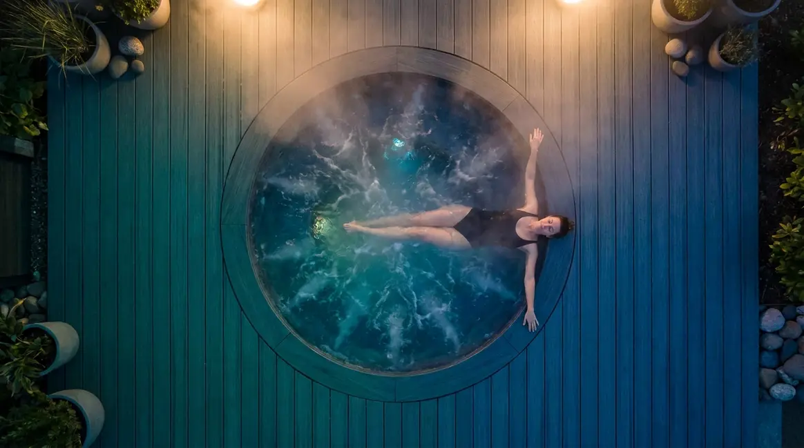 Person relaxing in steaming hot tub illustrating the question do you sweat in a hot tub