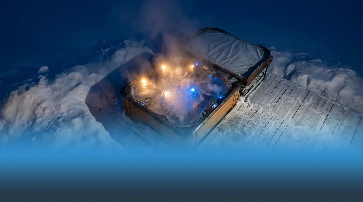 What temperature is too cold for a hot tub — steaming hot tub surrounded by snow in winter